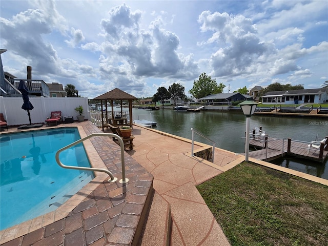 view of pool with fence, a dock, a fenced in pool, a gazebo, and a water view