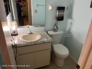 bathroom with vanity, toilet, and tile patterned floors