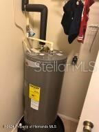 utility room featuring water heater