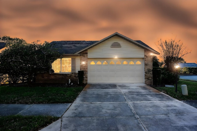 ranch-style home with brick siding, driveway, and an attached garage