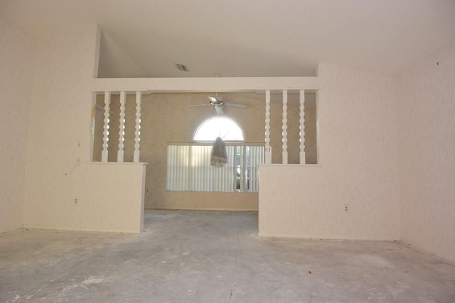 spare room featuring visible vents, vaulted ceiling, and unfinished concrete floors