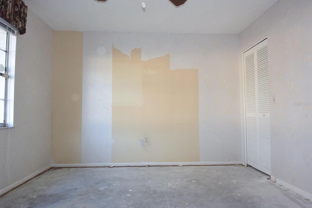 empty room featuring a healthy amount of sunlight and baseboards