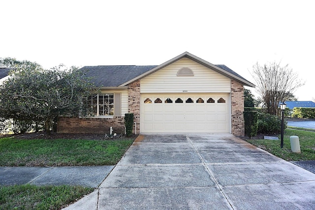 single story home with brick siding, driveway, and an attached garage