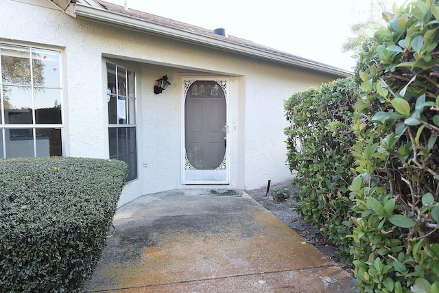 doorway to property with stucco siding