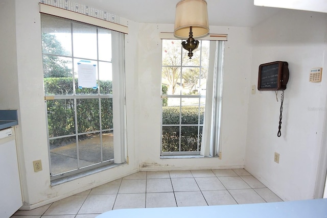 doorway featuring light tile patterned flooring