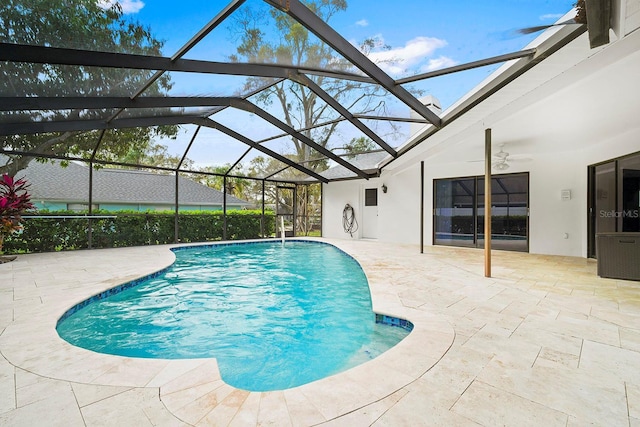 pool featuring a lanai, a patio area, and ceiling fan