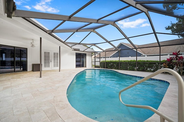 pool featuring french doors, glass enclosure, and a patio