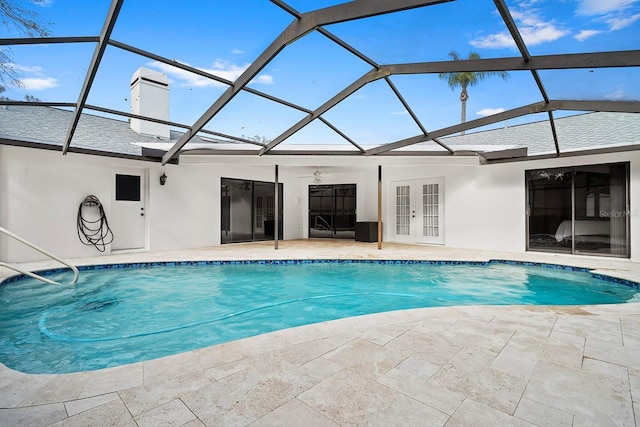 pool with french doors, glass enclosure, and a patio