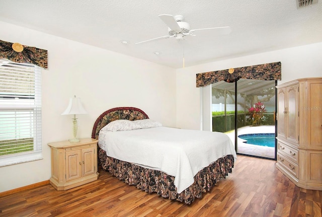 bedroom featuring light wood-style floors, a ceiling fan, a textured ceiling, access to outside, and baseboards