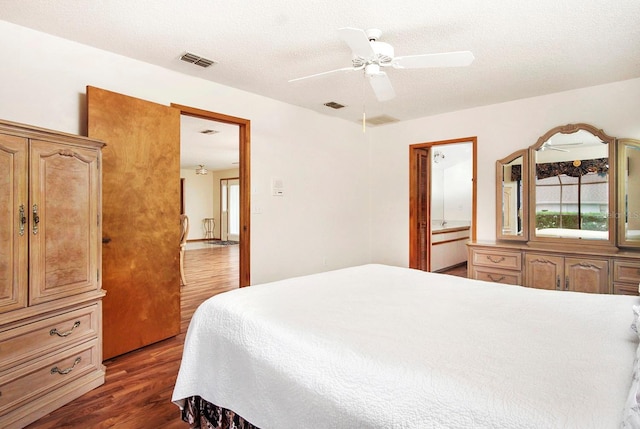 bedroom with visible vents, ceiling fan, a textured ceiling, and wood finished floors