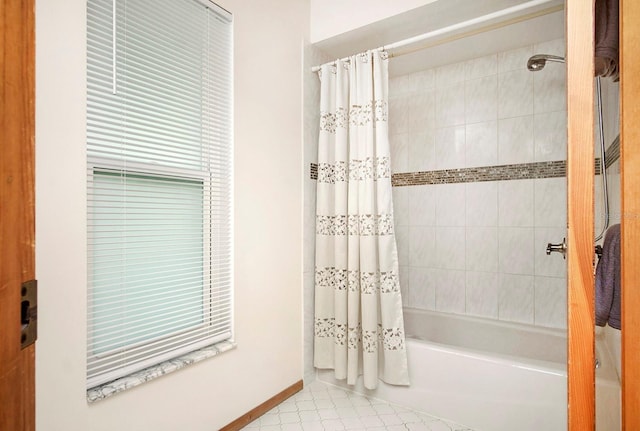 full bathroom featuring baseboards and shower / bath combo with shower curtain