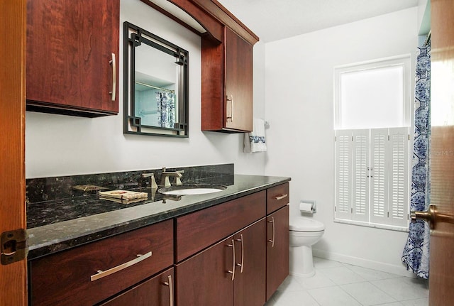 full bathroom featuring baseboards, vanity, toilet, and tile patterned floors