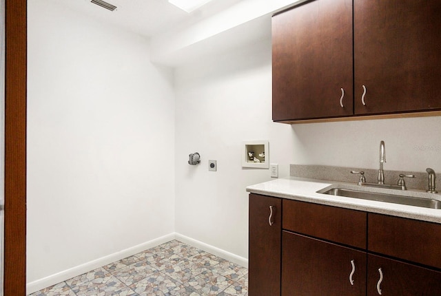 clothes washing area with hookup for a washing machine, cabinet space, a sink, electric dryer hookup, and baseboards