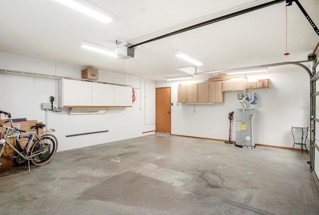 garage with a garage door opener, electric water heater, and baseboards