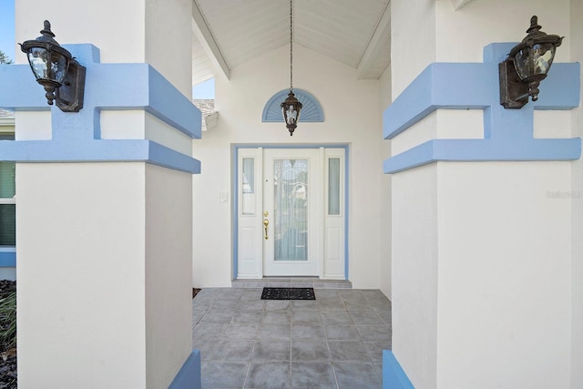 entrance to property featuring stucco siding