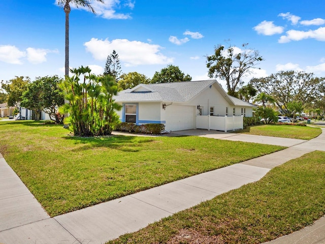 view of home's exterior featuring a yard, driveway, an attached garage, and stucco siding