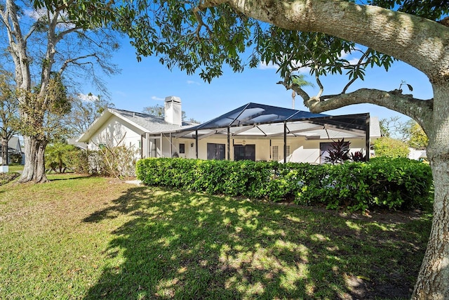 view of yard with glass enclosure