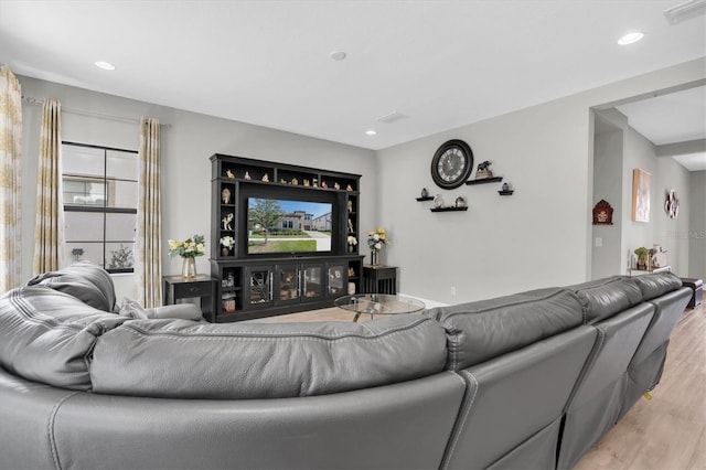 living room with recessed lighting, visible vents, and light wood-style floors