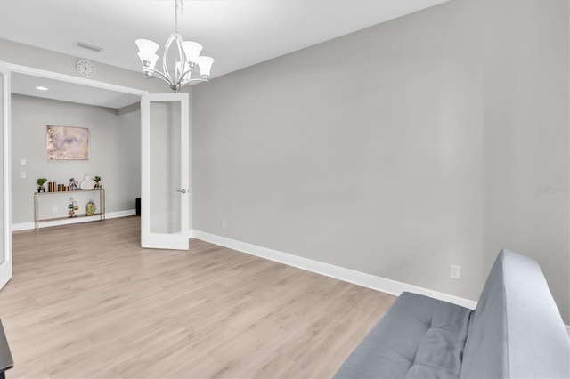 interior space with a chandelier, visible vents, baseboards, french doors, and light wood-type flooring