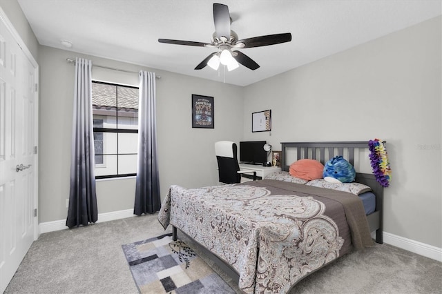 bedroom featuring baseboards, a ceiling fan, and light colored carpet