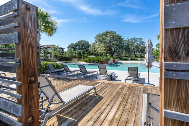 wooden terrace featuring an outdoor pool