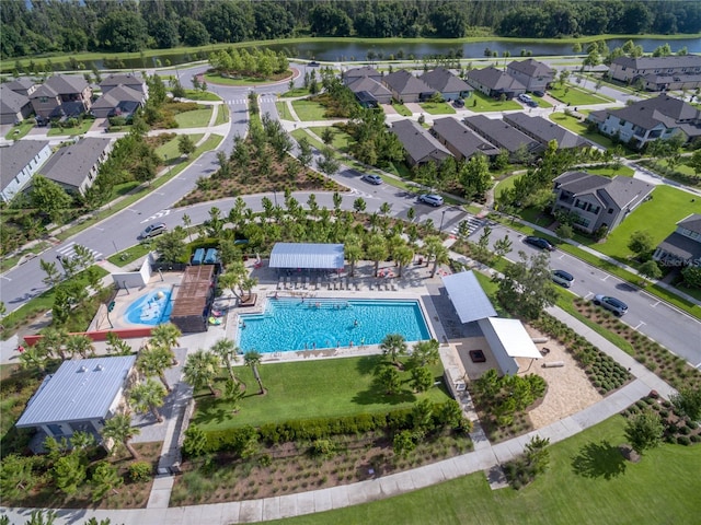 birds eye view of property with a water view and a residential view