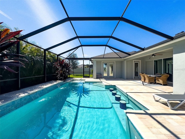 view of swimming pool featuring a patio, glass enclosure, and a fenced in pool