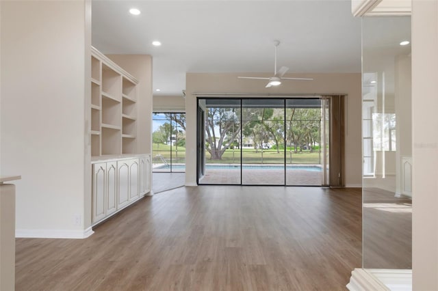 unfurnished living room with light wood-style floors, recessed lighting, ceiling fan, and baseboards