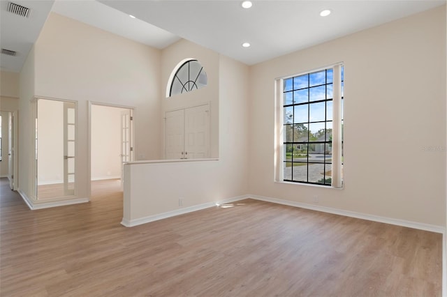 spare room with light wood-type flooring, visible vents, baseboards, and recessed lighting