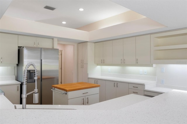 kitchen featuring stainless steel fridge, visible vents, open shelves, backsplash, and recessed lighting