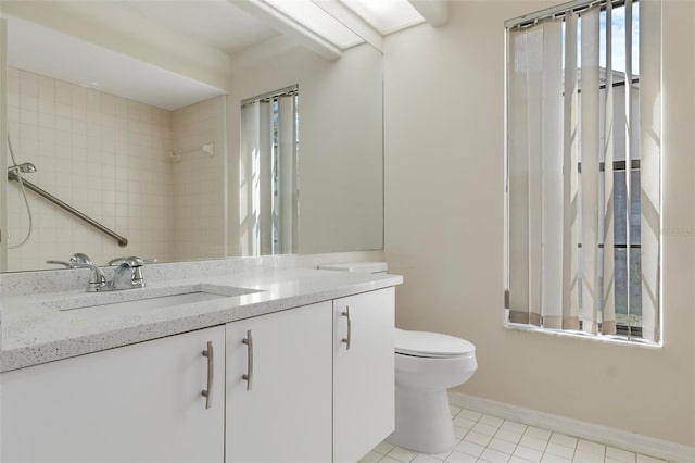 bathroom with vanity, tile patterned flooring, toilet, and baseboards