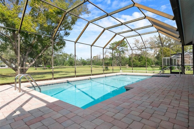 pool featuring a yard, glass enclosure, and a patio