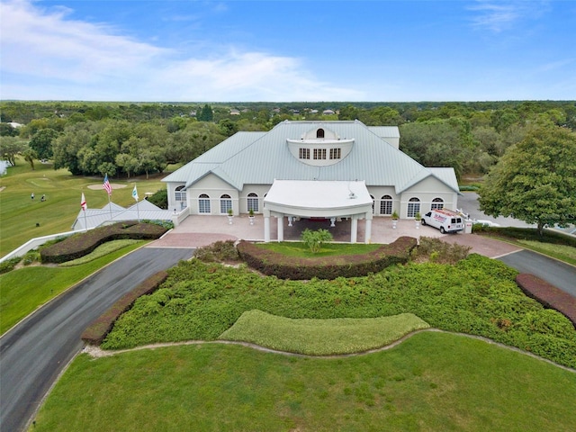 birds eye view of property featuring a view of trees