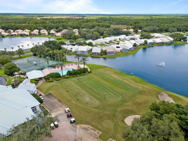 bird's eye view with a residential view, view of golf course, a water view, and a view of trees