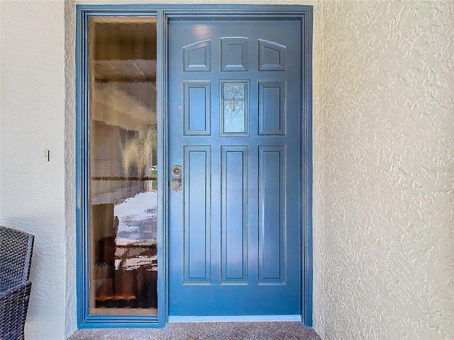 doorway to property with stucco siding