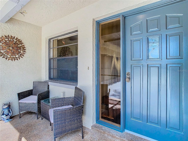 view of exterior entry featuring stucco siding