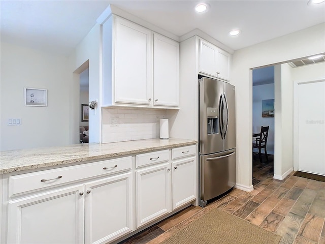 kitchen with stainless steel fridge, white cabinetry, tasteful backsplash, and wood finish floors