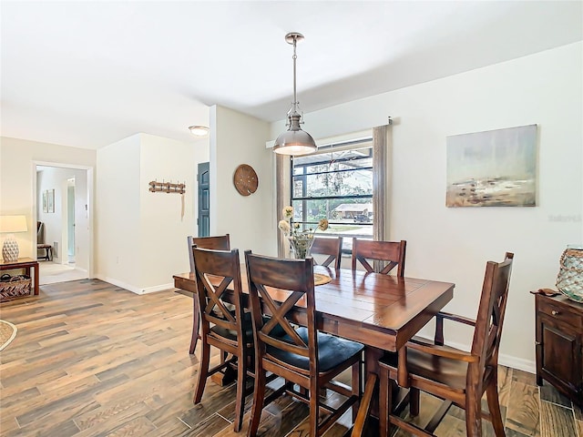 dining room featuring baseboards and wood finished floors