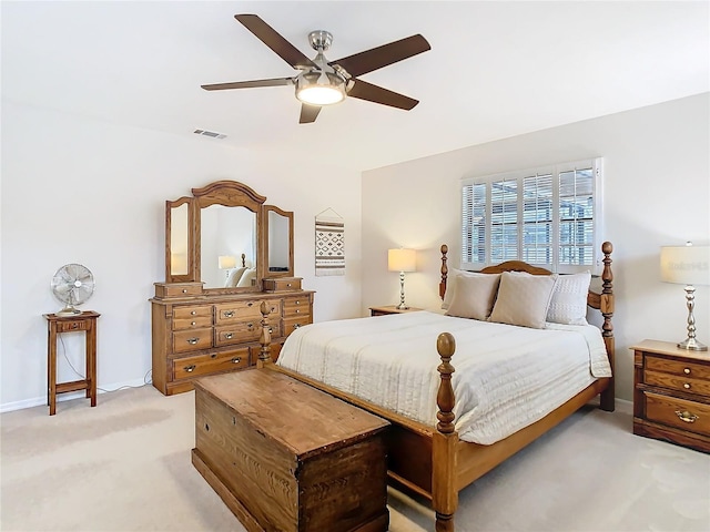 bedroom featuring light carpet, ceiling fan, visible vents, and baseboards