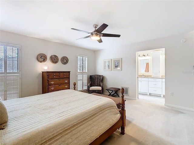 bedroom featuring light carpet, multiple windows, visible vents, and baseboards