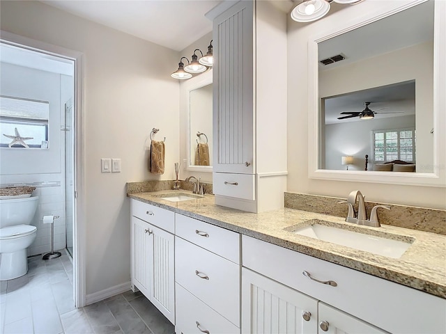 full bathroom with visible vents, a sink, toilet, and double vanity