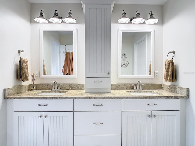 bathroom with a sink and double vanity