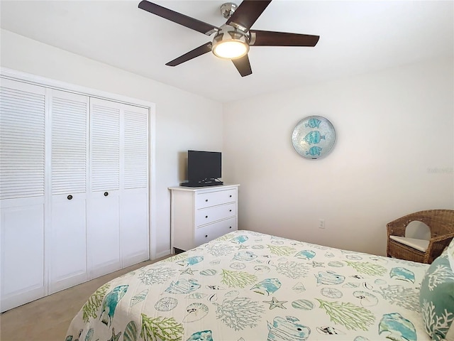 bedroom featuring light carpet, a closet, and a ceiling fan