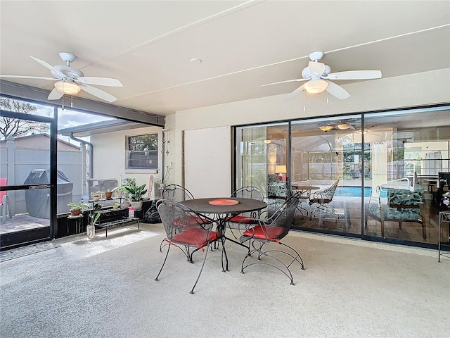 sunroom / solarium featuring ceiling fan