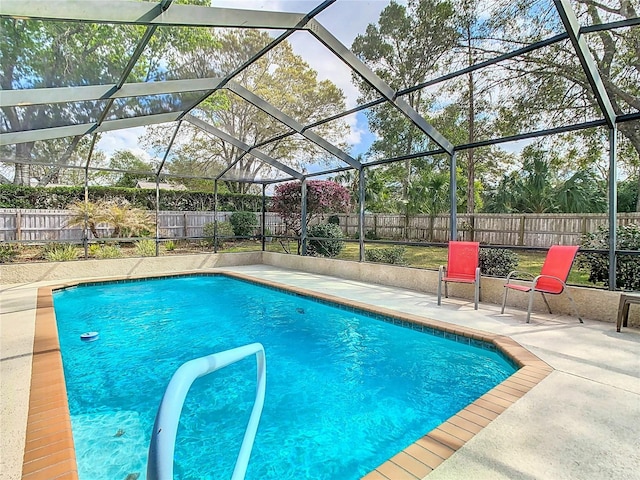 view of swimming pool featuring a patio, a fenced backyard, a fenced in pool, and a lanai