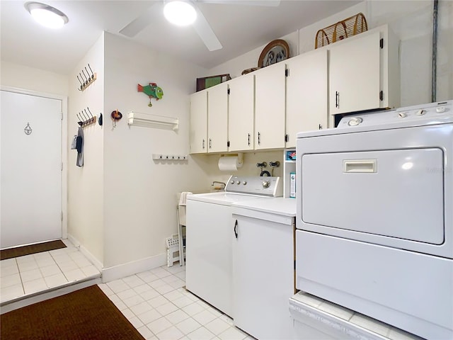 clothes washing area featuring cabinet space, light tile patterned floors, baseboards, washer and clothes dryer, and ceiling fan