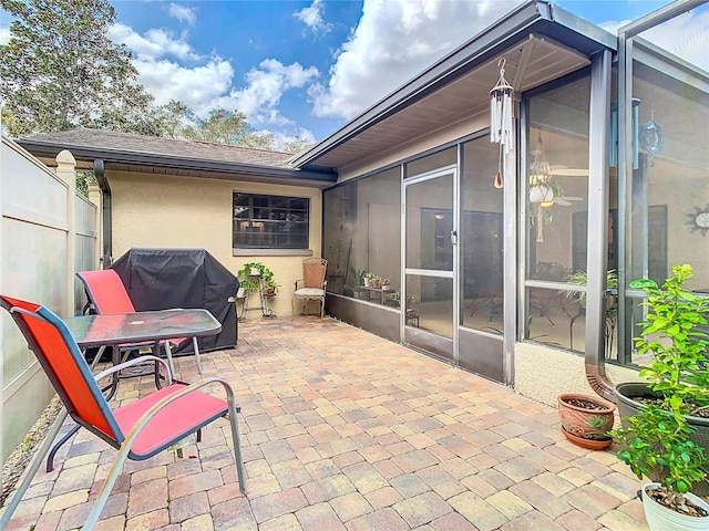 view of patio with grilling area and a sunroom