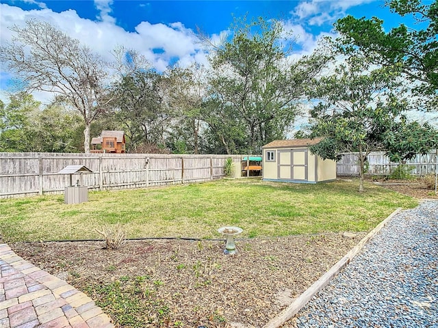 view of yard with a storage shed, a fenced backyard, and an outdoor structure