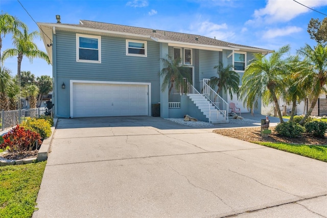 view of front of property with a garage, fence, and concrete driveway