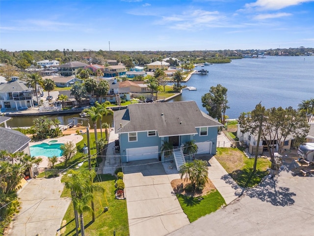 drone / aerial view featuring a water view and a residential view